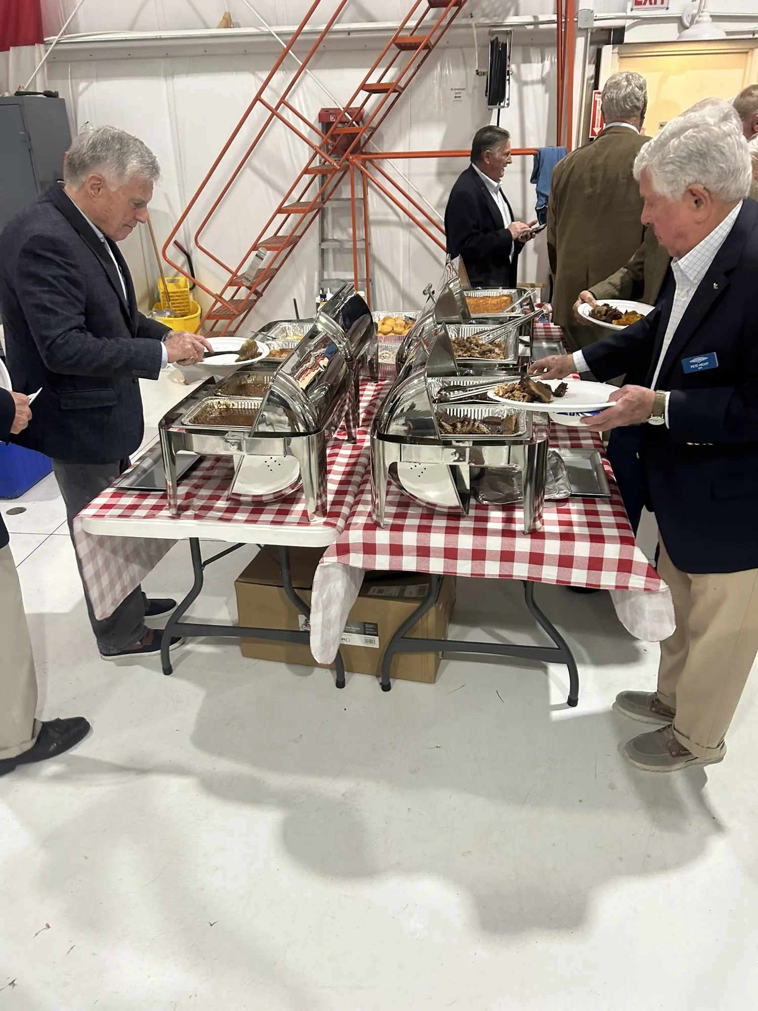 Catering buffet with chafing dishes and guests