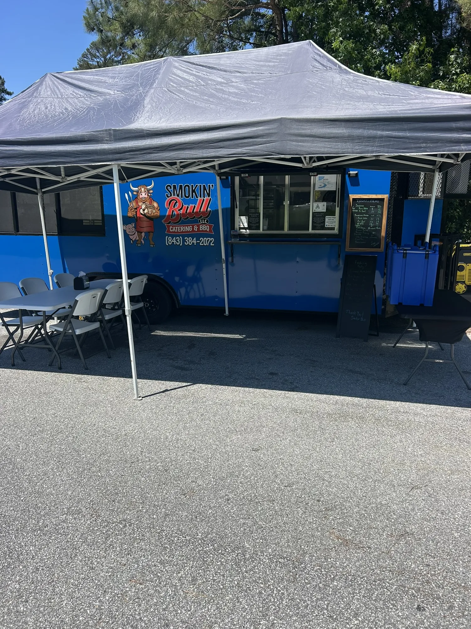 Smokin' Bull food truck canopy setup at an event