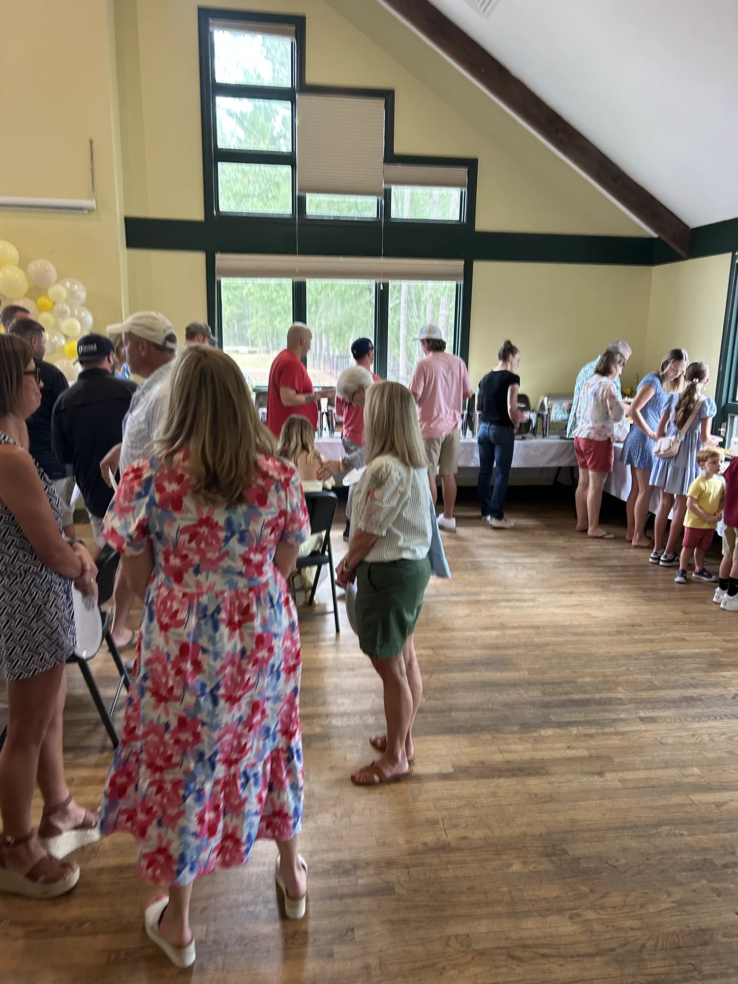 Guests mingling near the buffet line at a private event